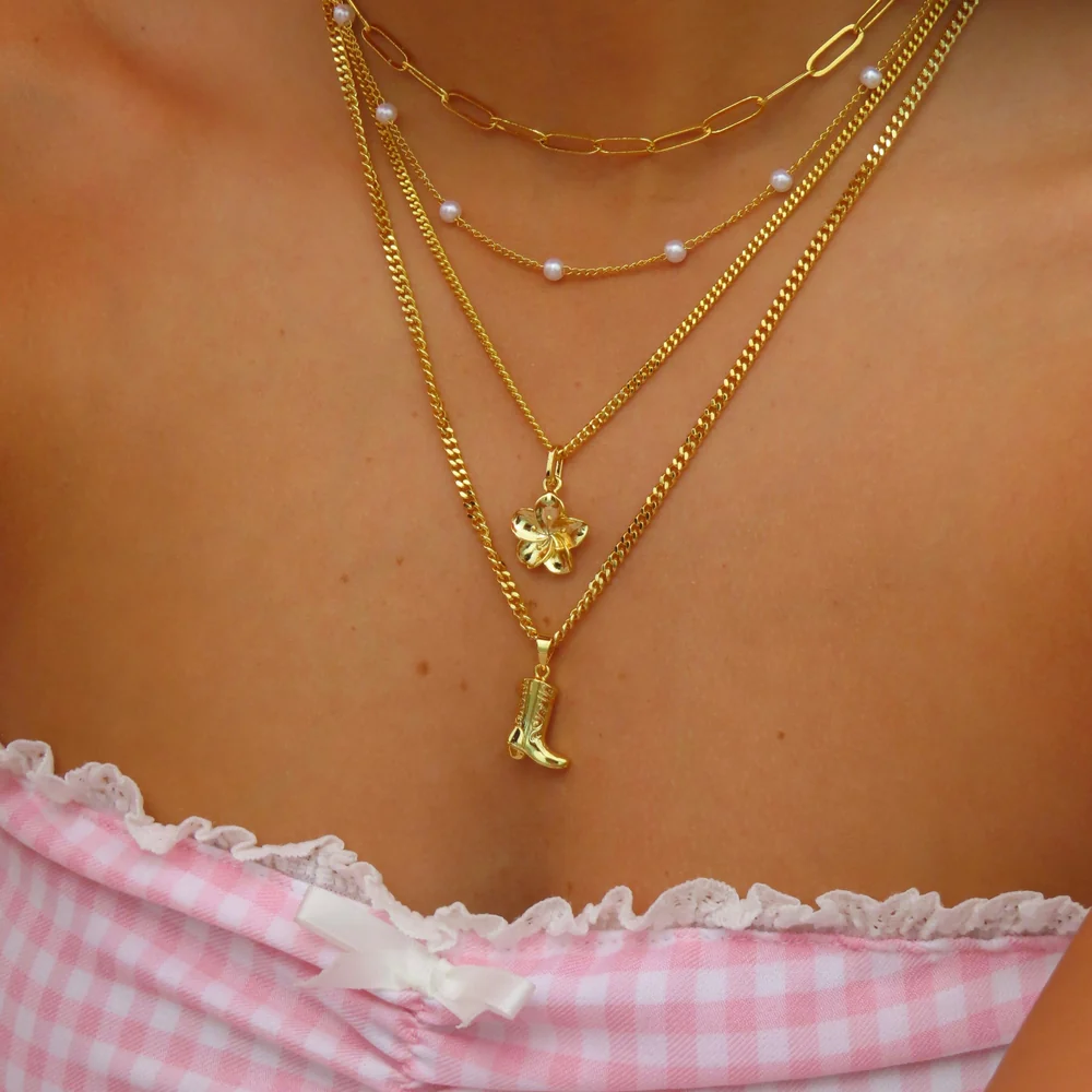 Lover Girl Necklace layered with gold chains and pendants